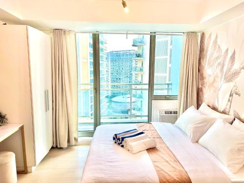 a bedroom with a bed with a large window at Azure Urban Resort South Paranaque Beach View Unit- Newly Renovated - Near Airport Near SM Bicutan in Manila