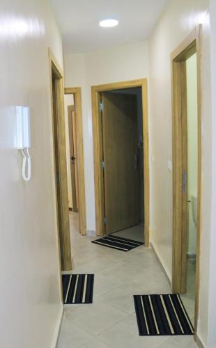 a hallway with two mirrors in a hotel room at Appartement vue panoramique sur mer Avec Climatisation! à 5 minutes à pied de la Plage ! à environ 6 minutes en voiture du Centre d'Agadir et à 10 minutes en voiture de Taghazout ! in Agadir