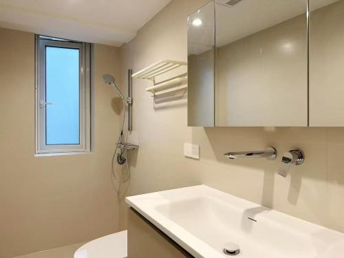 um banheiro com uma pia, um vaso sanitário e uma janela em Sunny Abode 中远A 2Bedroom river view near Suzhou River em Xangai