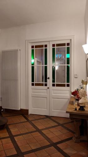 a room with a white door and a table at Repos à Ribérac B&B in Ribérac