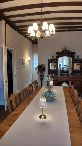 a dining room with a long table and chairs at Repos à Ribérac B&B in Ribérac