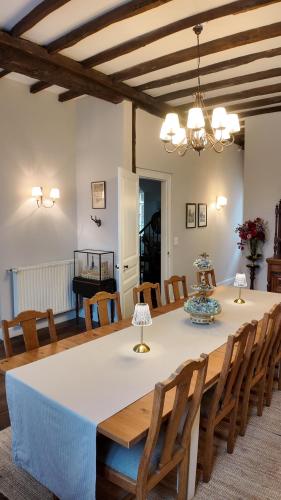 a dining room with a white table and chairs at Repos à Ribérac B&B in Ribérac