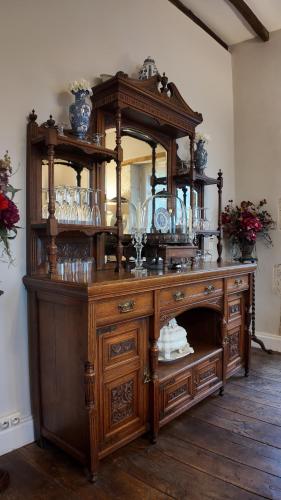 a large wooden dresser with a mirror in a room at Repos à Ribérac B&B in Ribérac