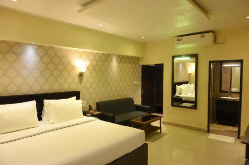 Postel nebo postele na pokoji v ubytování The Citi Residenci Hotel, Bidhannagar