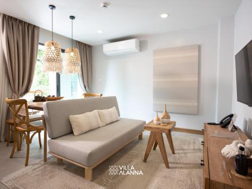 a living room with a couch and a table at Villa ALANNA in Chiang Mai
