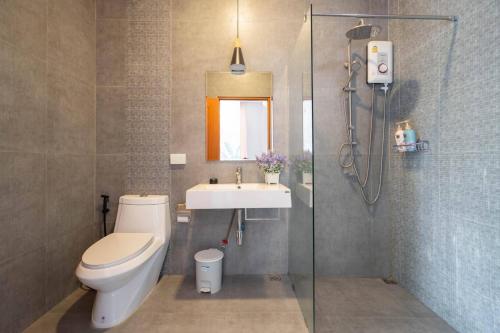 a bathroom with a toilet and a sink and a shower at Hua Hin Pool Villa and Pool table with 3 bedrooms, 3 bathrooms near Cha-Am beach in Nikhom Sang Ton Eng Khuan Phet