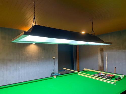 a light above a pool table in a room at Hua Hin Pool Villa and Pool table with 3 bedrooms, 3 bathrooms near Cha-Am beach in Nikhom Sang Ton Eng Khuan Phet
