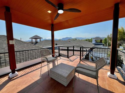 a porch with two chairs and a ceiling fan at Hua Hin Pool Villa and Pool table with 3 bedrooms, 3 bathrooms near Cha-Am beach in Nikhom Sang Ton Eng Khuan Phet