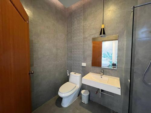 a bathroom with a toilet and a sink at Hua Hin Pool Villa and Pool table with 3 bedrooms, 3 bathrooms near Cha-Am beach in Nikhom Sang Ton Eng Khuan Phet