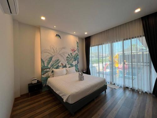 a bedroom with a bed and a large window at Hua Hin Pool Villa and Pool table with 3 bedrooms, 3 bathrooms near Cha-Am beach in Nikhom Sang Ton Eng Khuan Phet