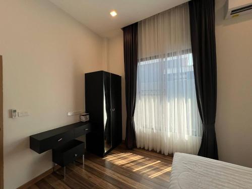 a bedroom with a bed and a dresser and a window at Hua Hin Pool Villa and Pool table with 3 bedrooms, 3 bathrooms near Cha-Am beach in Nikhom Sang Ton Eng Khuan Phet