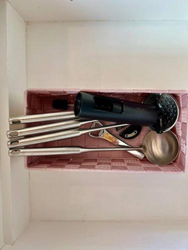 a wine bottle and utensils on a shelf at Hua Hin Pool Villa and Pool table with 3 bedrooms, 3 bathrooms near Cha-Am beach in Nikhom Sang Ton Eng Khuan Phet