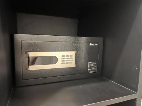 a microwave oven sitting on top of a shelf at Hua Hin Pool Villa and Pool table with 3 bedrooms, 3 bathrooms near Cha-Am beach in Nikhom Sang Ton Eng Khuan Phet