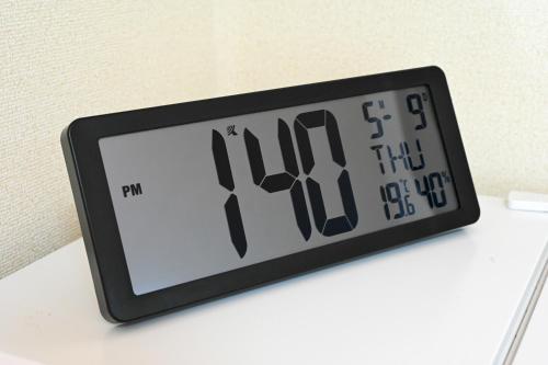 a clock sitting on top of a white table at Bhome Hikone Jizo in Hikone
