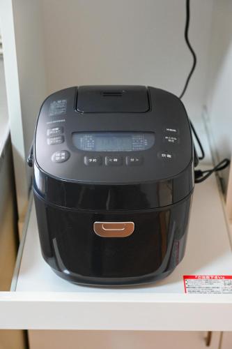 a black appliance sitting on top of a shelf at Bhome Hikone Jizo in Hikone
