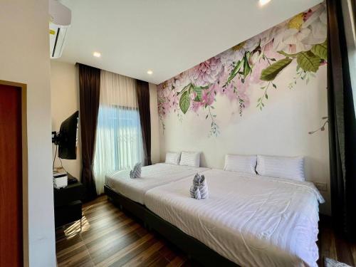 two cats sitting on a bed in a bedroom at Hua Hin Pool Villa and Pool table with 3 bedrooms, 3 bathrooms near Cha-Am beach in Nikhom Sang Ton Eng Khuan Phet
