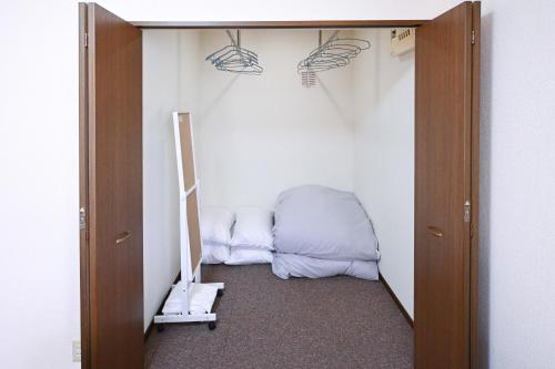 a room with a closet with a bed in it at Bhome Hikone Jizo in Hikone