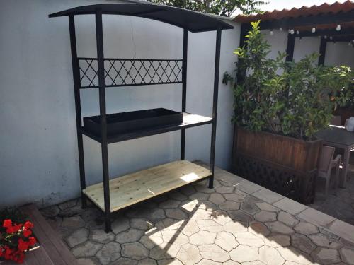a black book shelf sitting next to a wall at Sunnyside Bilgah villa 2 in Baku
