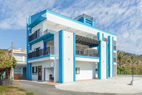a blue and white building with balconies at Xiao San Chill in Xiaoliuqiu