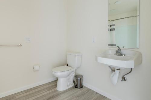 a white bathroom with a toilet and a sink at Blueground Berkeley AC wd nr UC Theatre SFO-1814 in San Francisco