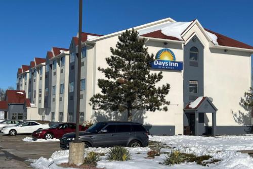a view of a dixon inn in a parking lot at Days Inn by Wyndham near Kansas Speedway in Kansas City