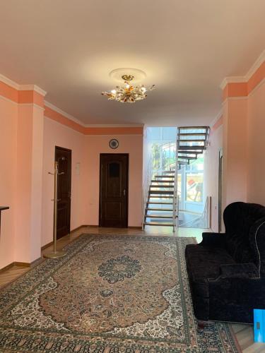 a living room with a couch and a chandelier at Гостевой дом "Светлана" in Cholpon-Ata
