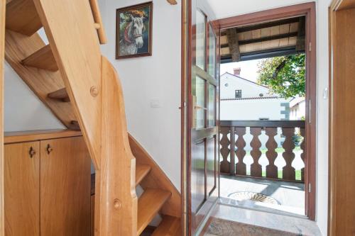 a wooden staircase leading to the second floor of a house at Hiška Kovačija in Vremski Britof