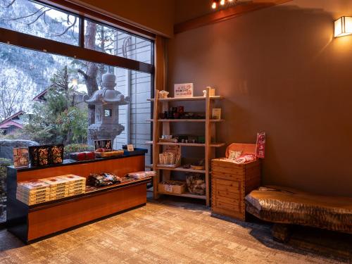 a room with a book shelf and a window at Ryokan Gizan in Takayama