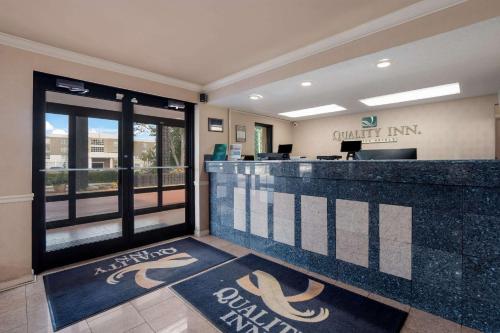 a lobby with a counter with a volleyball team on it at Quality Inn Fort Jackson in Columbia