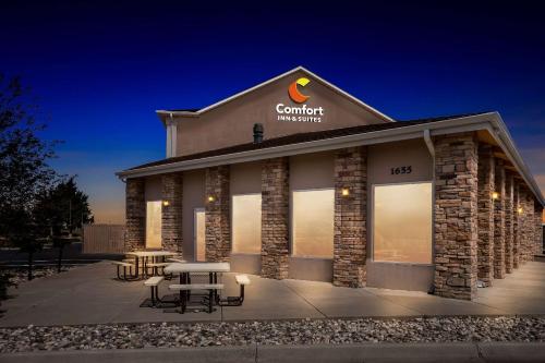 a building with a picnic table in front of it at Comfort Inn & Suites Near University of Wyoming in Laramie