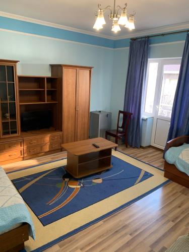 a living room with a couch and a coffee table at Гостевой дом "Светлана" in Cholpon-Ata