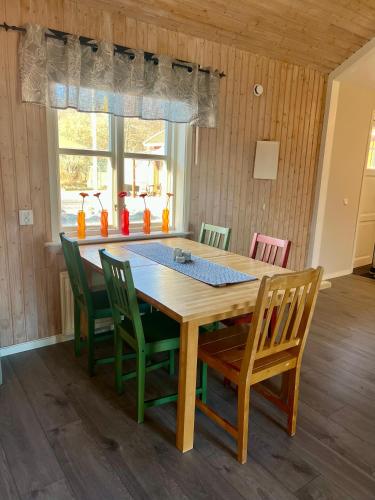 a dining room table with four chairs around it at Fiskebäckgårds gästhus in Lysekil