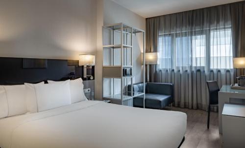 A bed or beds in a room at AC Hotel Atocha by Marriott
