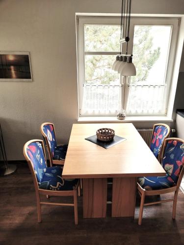 a dining room with a wooden table and chairs at Zinnowitz, Dünenstr 36 WE 15 in Zinnowitz