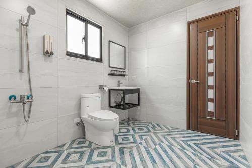a bathroom with a toilet and a window at Xiao San Chill in Xiaoliuqiu
