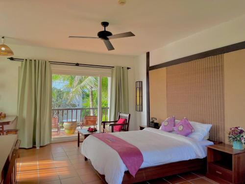Un dormitorio con una cama grande y un balcón. en Melon Resort & Pickleball Club Mũi Né, en Phan Thiet