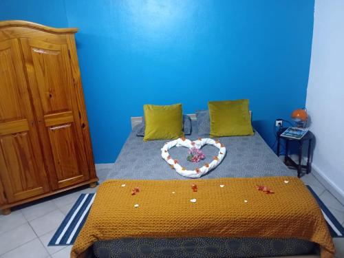 a bedroom with a bed with a heart made up at Gite Oiseau du Paradis in Le Marin