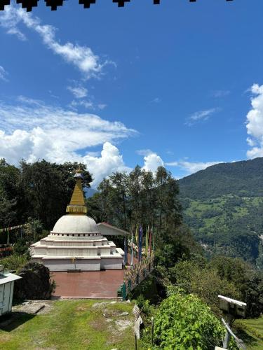 a building with a gold top on top of it at Taj Guras Kutir Resort & Spa, Gangtok in Gangtok