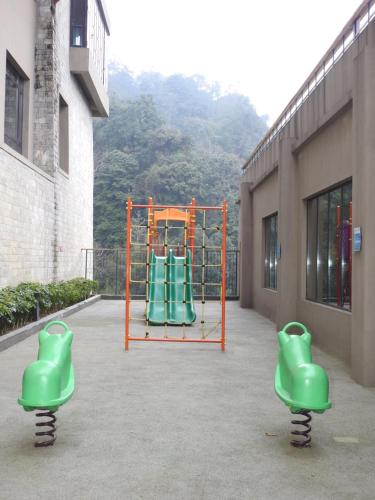 a playground with green equipment in a building at Taj Guras Kutir Resort & Spa, Gangtok in Gangtok