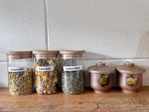 a group of four jars of food on a table at White Rabbit Mountain Guest House in Mount Beauty