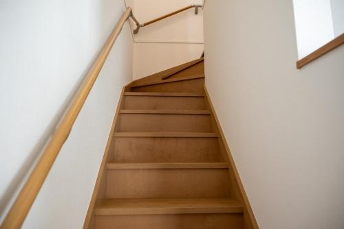 a staircase in a house with wooden floors at ライトハウス旭川 in Asahikawa