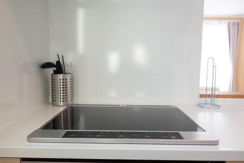 a kitchen counter with a stove top oven at ライトハウス旭川 in Asahikawa