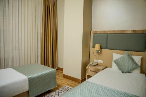 Postel nebo postele na pokoji v ubytování Mari Suites Hotel