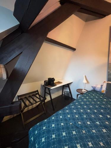 a bedroom with a bed and a desk in a room at B&B Het Havenhuis in Bruges