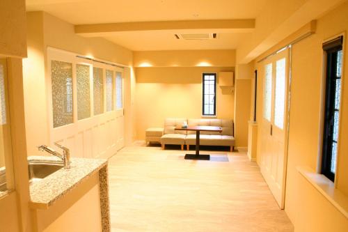 a hospital hallway with a couch and a table at 916旅の宿 in Fujiyoshida