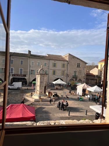 a view from a window of a courtyard with buildings at Eymet Holiday Rentals in Eymet