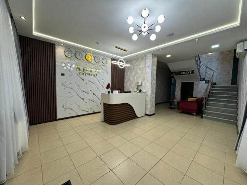 a lobby with a reception desk in a building at Aden City Hotel in Baku