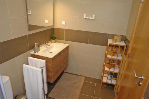 a bathroom with a sink and a mirror at Cascais 4 You in Cascais