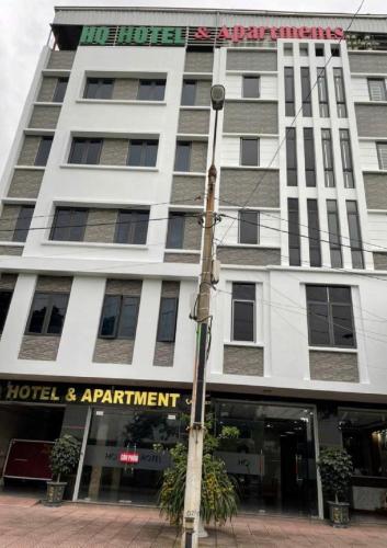 a hotel and apartment building on a city street at HQ Hotel & Apartment in Hai Phong