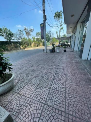 a brick sidewalk in front of a building at HQ Hotel & Apartment in Hai Phong